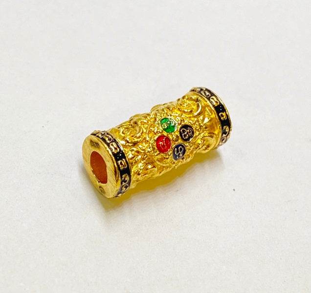 Golden charm and attraction Thai talisman featuring intricate detailing and colorful accents