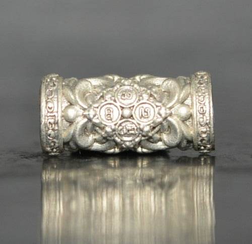 Decorative silver Thai talisman with intricate designs for charm and attraction Thai talisman