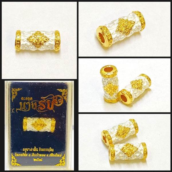 Thai talisman charm and attraction decoration with intricate gold and white design in a gift box