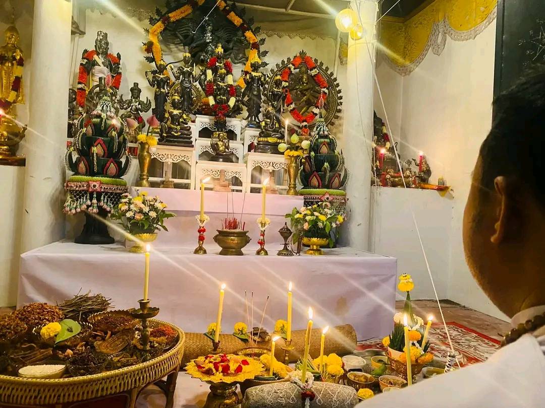 Thai Blessing Co shrine featuring a cleanse negative energy Thai amulet surrounded by offerings and candles