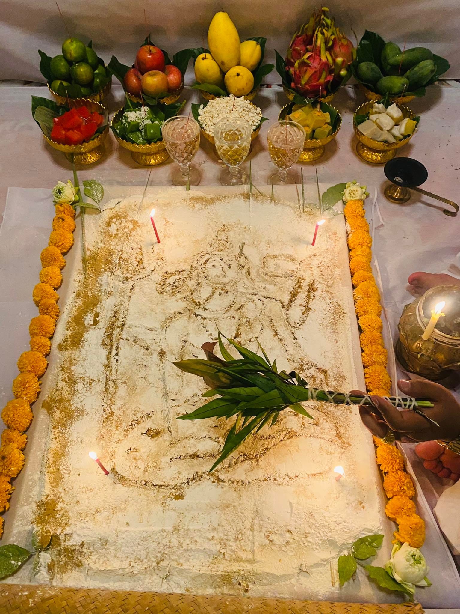 Ceremonial setup for a cleanse negative energy Thai amulet with offerings and flowers