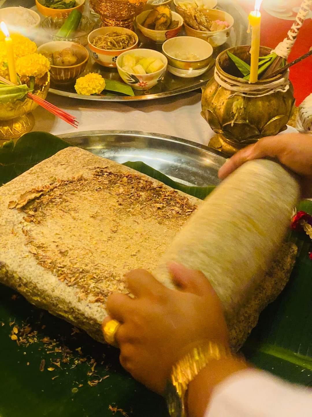 Ceremonial grinding of herbs for creating a cleanse negative energy Thai amulet