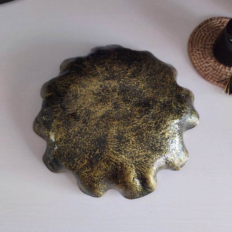 Decorative natural resin bowl 20cm with textured gold and black finish on white surface