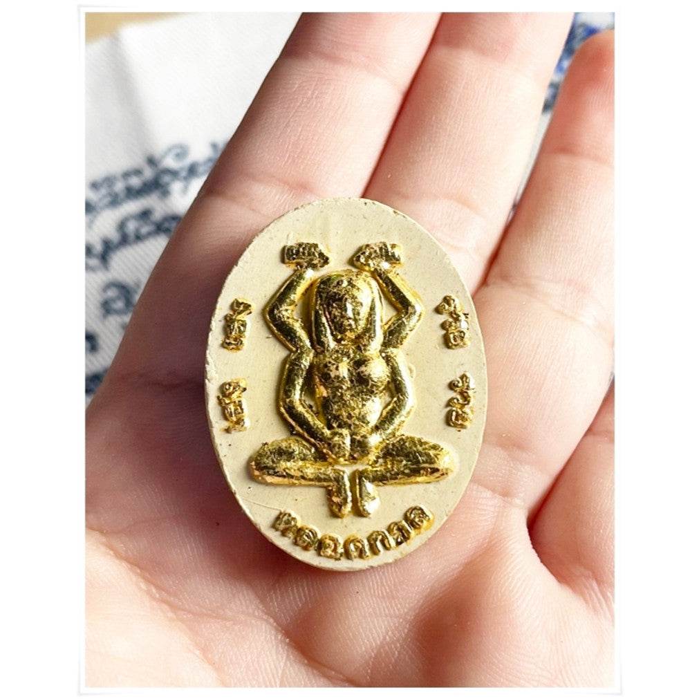 Divine attraction Thai charm in golden hue featuring a frog design for positive energy and good luck