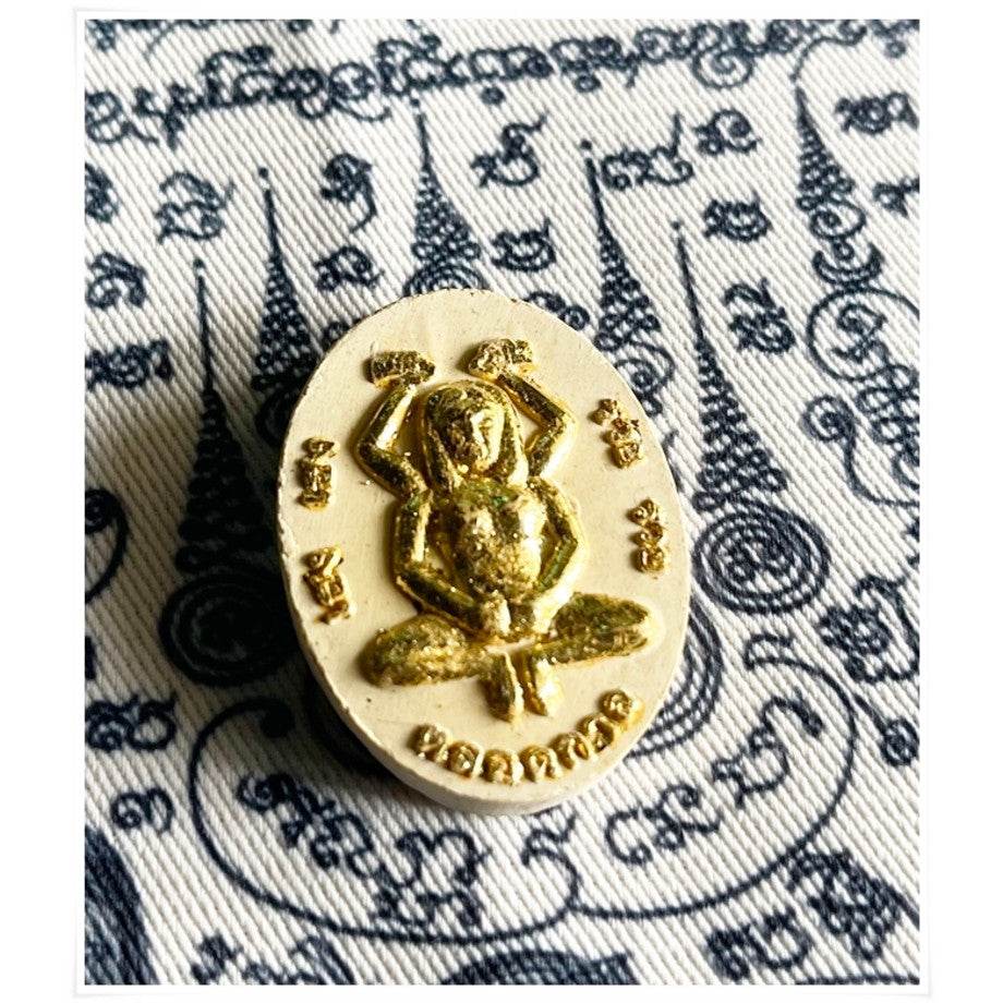 Divine attraction Thai charm amulet featuring intricate gold details for positive energy and blessings