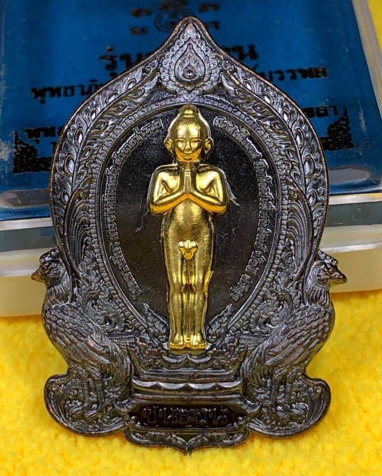 Ei Khai Phaya Kai bronze amulet with intricate design and golden standing figure on decorative base