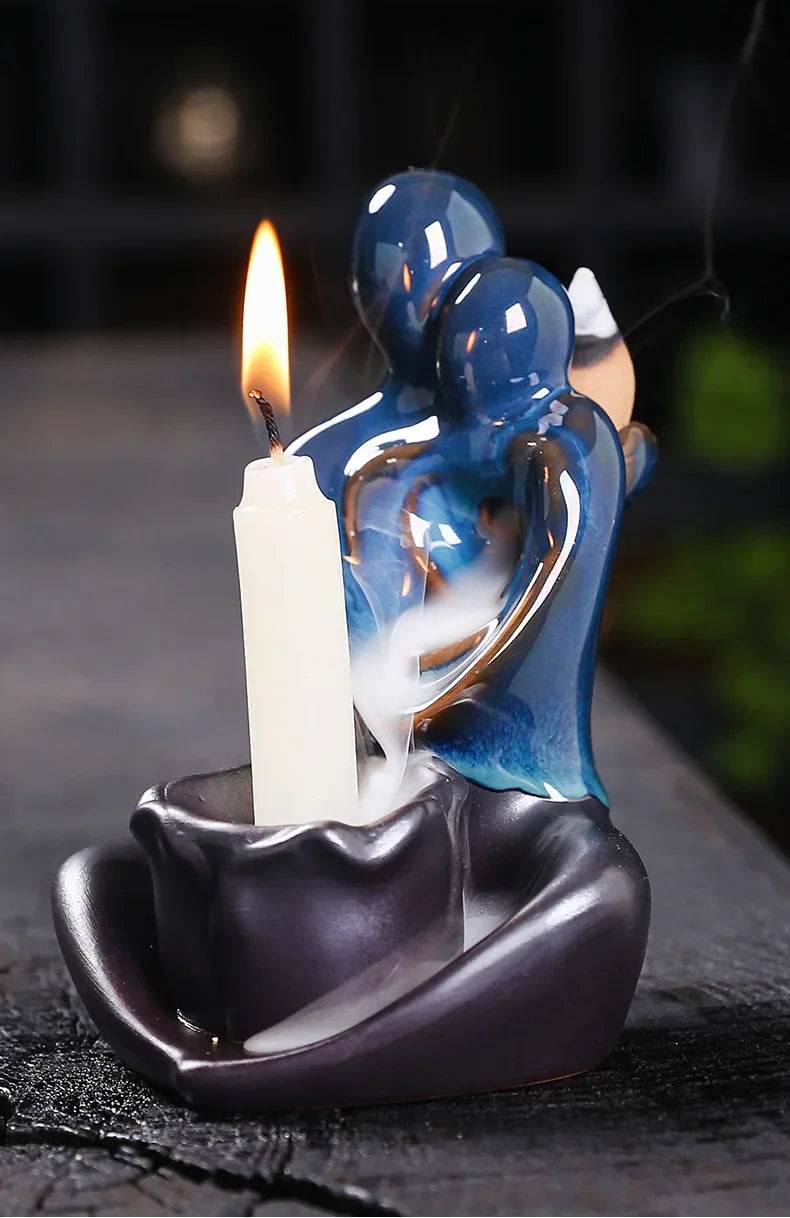Blue ceramic backflow incense burner of embracing figures with smoke waterfall and candle holder for decor