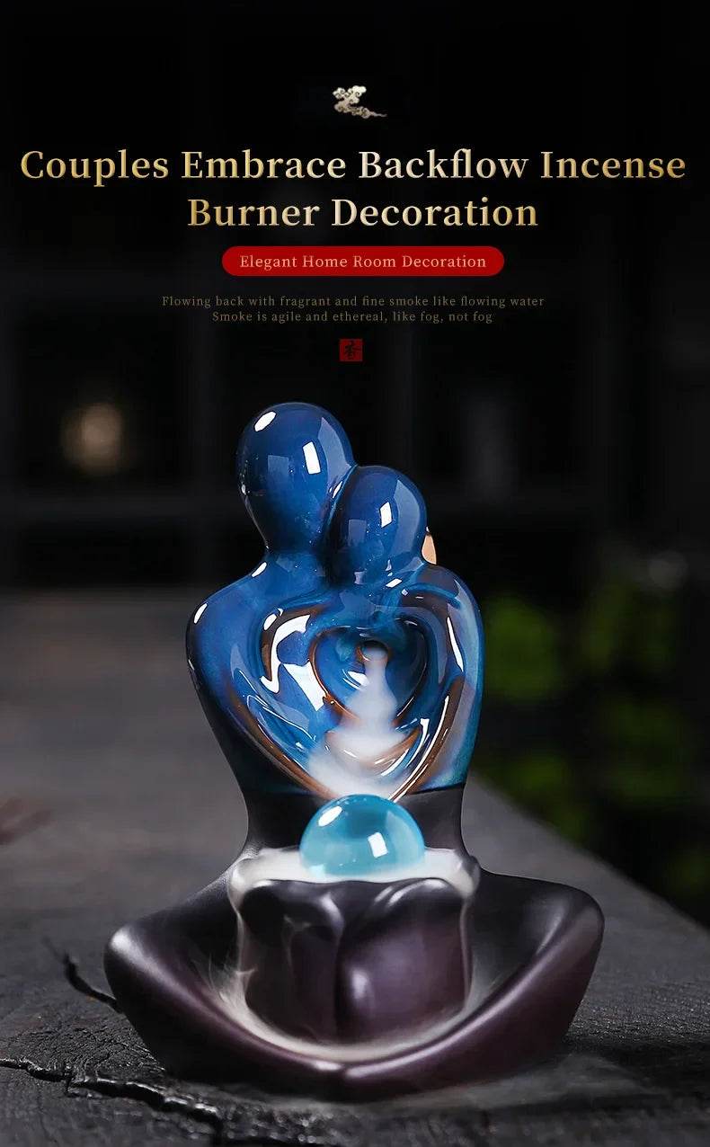 Glossy blue embracing couple sculpture ceramic backflow incense burner with cascading smoke on a dark base