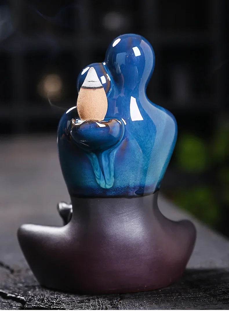 Thai Blessing Co blue glazed ceramic backflow incense burner in meditative figure design holding cone