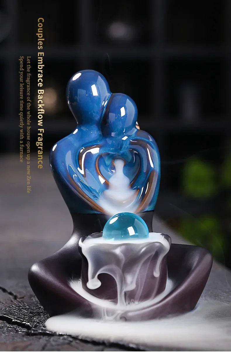 Blue couples embrace ceramic backflow incense burner with heart shape teal orb and cascading smoke waterfall