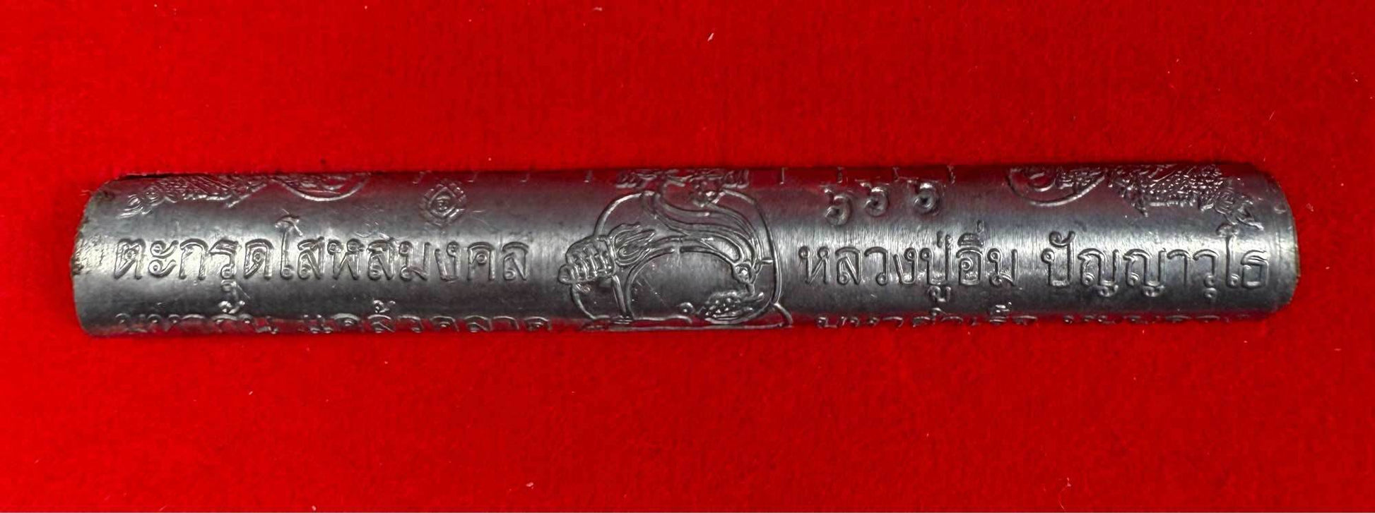 First edition collectible Thai blessing charm engraved metal rod on red background