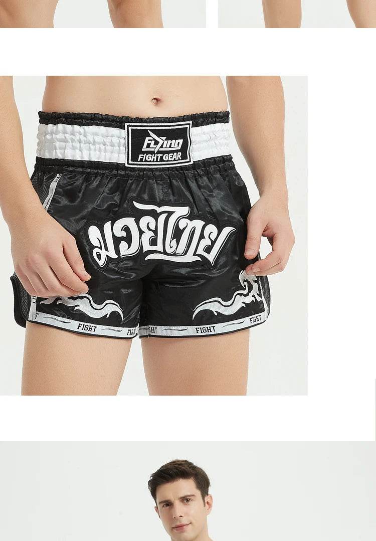 Black and white satin Muay Thai boxing shorts with Thai script logo and elastic high waist for training