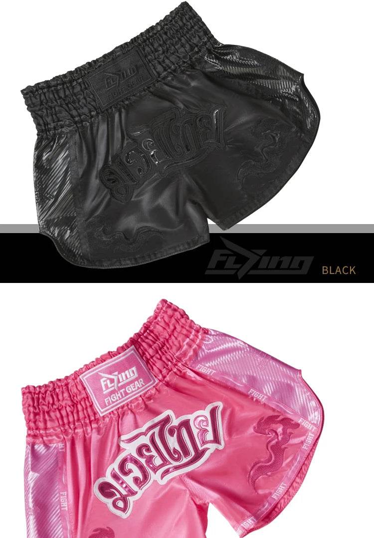 Muay Thai boxing shorts in black and pink by Thai Blessing Co showing elastic waist satin material and traditional cut