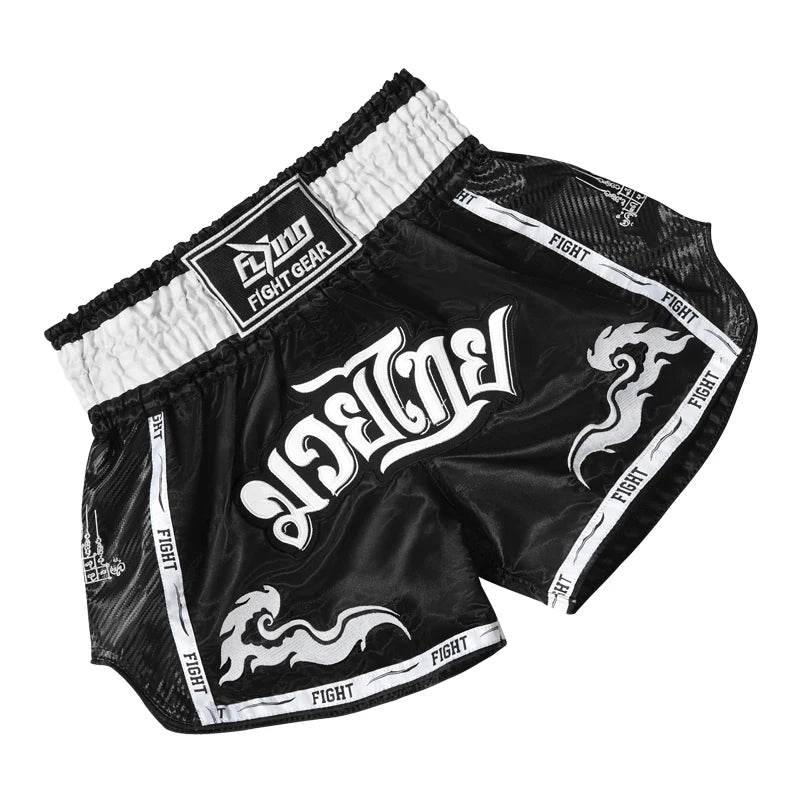 Black and white satin Muay Thai boxing shorts with elastic high waistband Thai script and dragon motifs