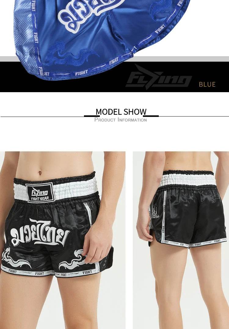 Muay Thai boxing shorts black satin with white waistband Thai script and contrast trim shown front and back on model