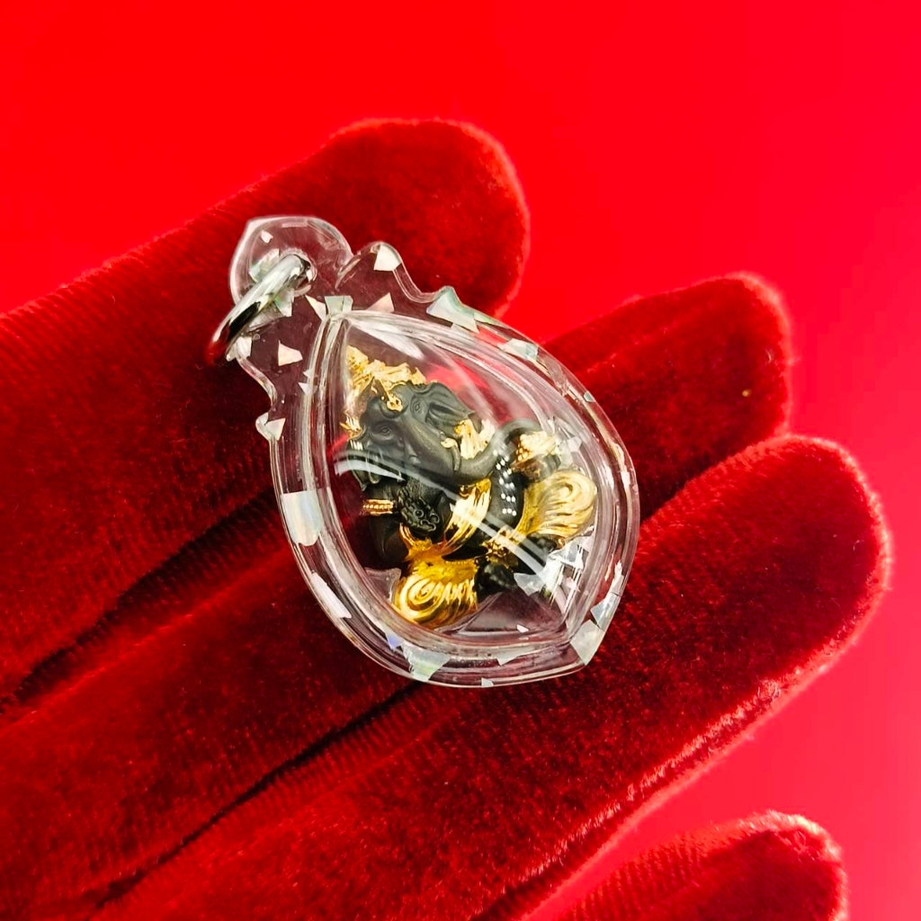 Clear Ganesh amulet for luck and success featuring intricate designs in a protective pendant