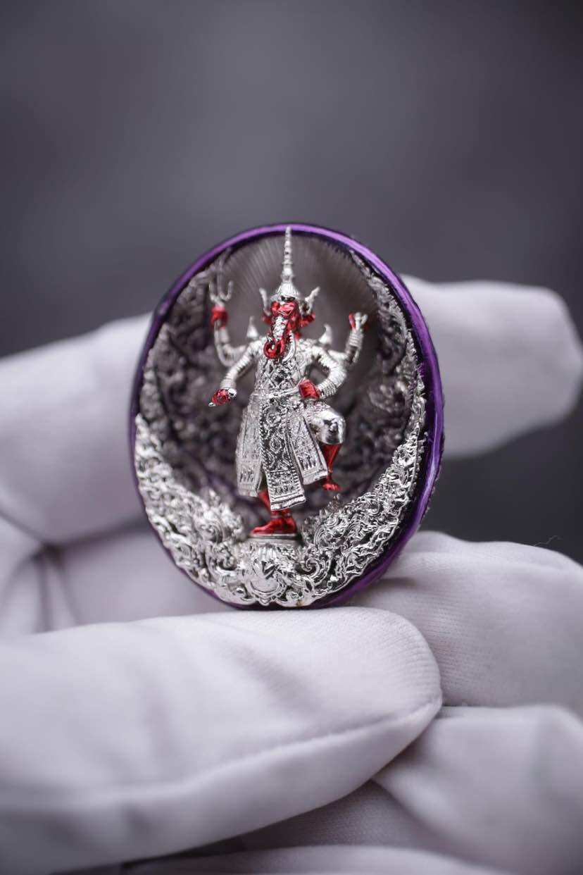 Detailed Ganesh coin amulet for wealth, featuring a vibrant figure of Ganesh in a decorative frame