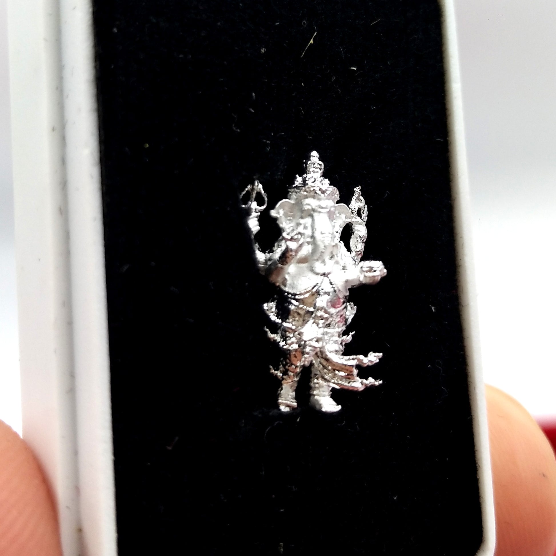 Silver Ganesha amulet for success displayed in a black velvet box, perfect for home decoration or gifting