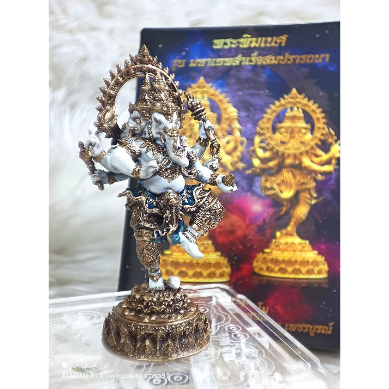 Intricately detailed Ganesha success fulfillment amulet statue in bronze and white on a decorative base with packaging