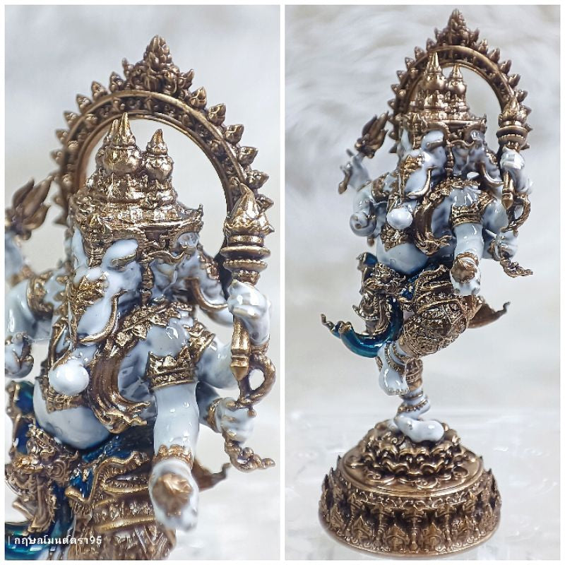 Intricately detailed Ganesha success fulfillment amulet statue with gold and blue accents on decorative base