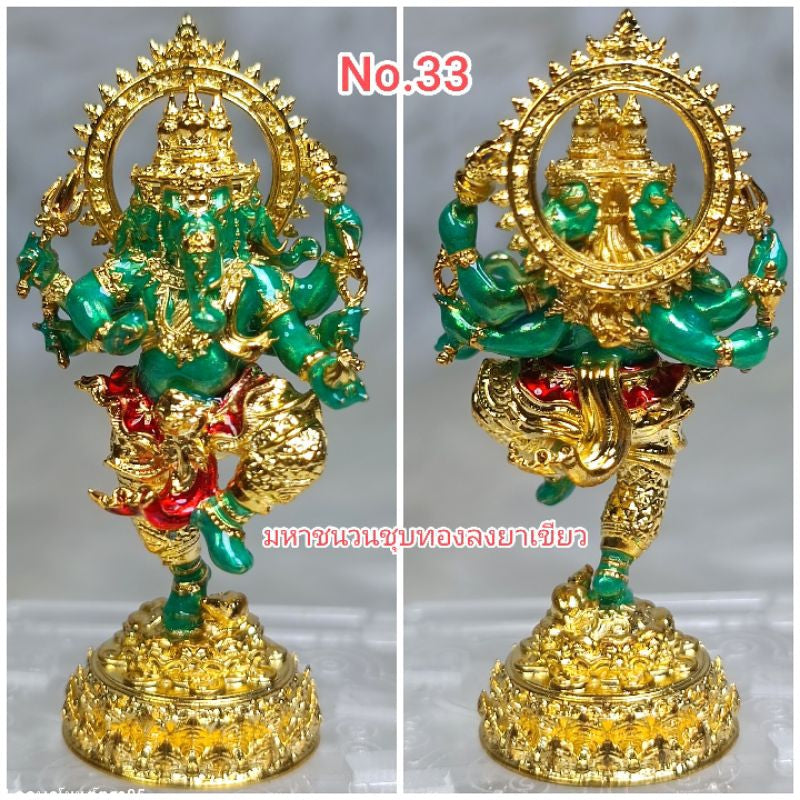 Green and gold Ganesha success fulfillment amulet statue with intricate details on ornate base