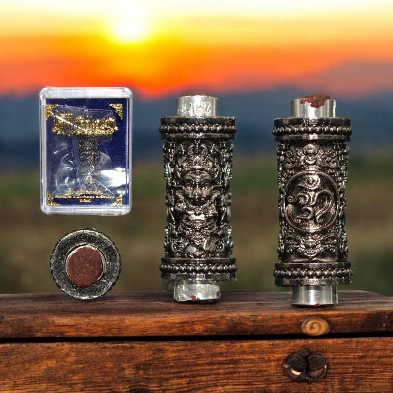 Ganesha Takrut amulet Thailand in silver with intricate designs and protective casing for spiritual blessings