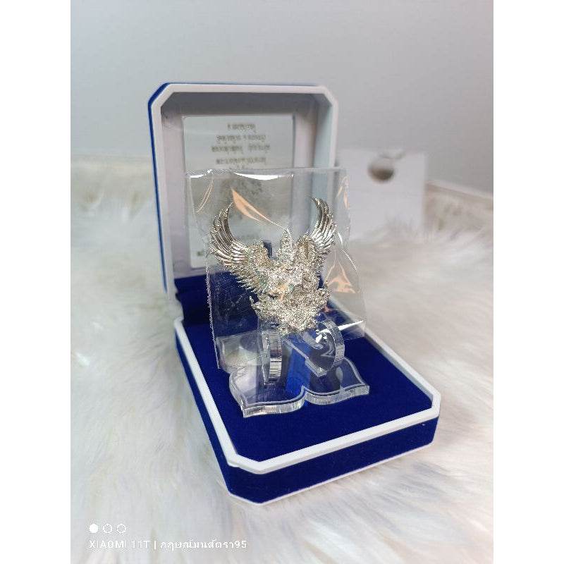 Silver Garuda amulet from Thailand displayed in a blue velvet jewelry box by Thai Blessing Co