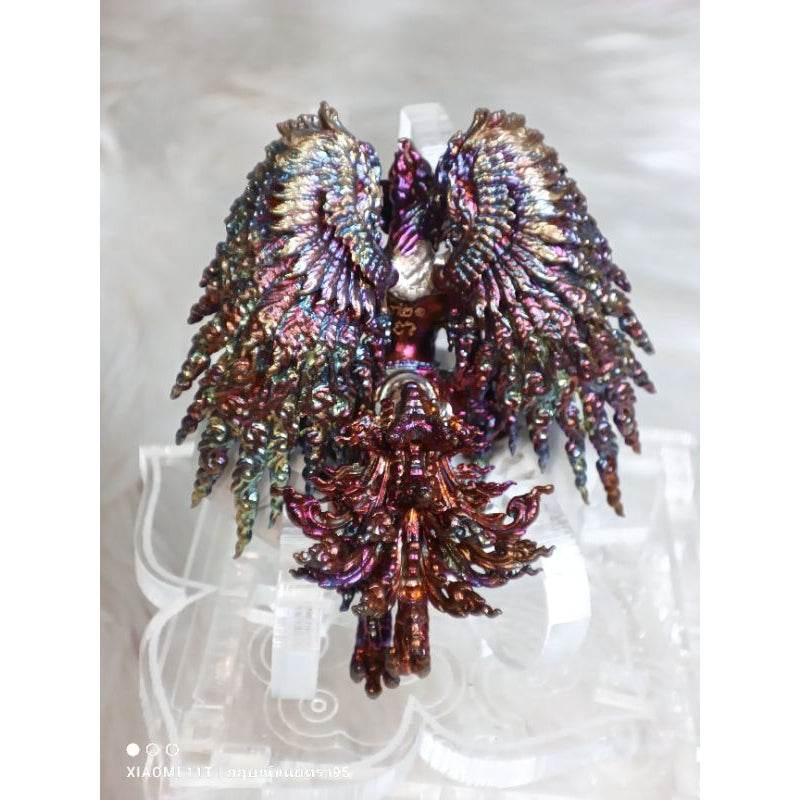 Intricate multicolor Garuda Parameswara amulet with detailed wing and body design on clear stand