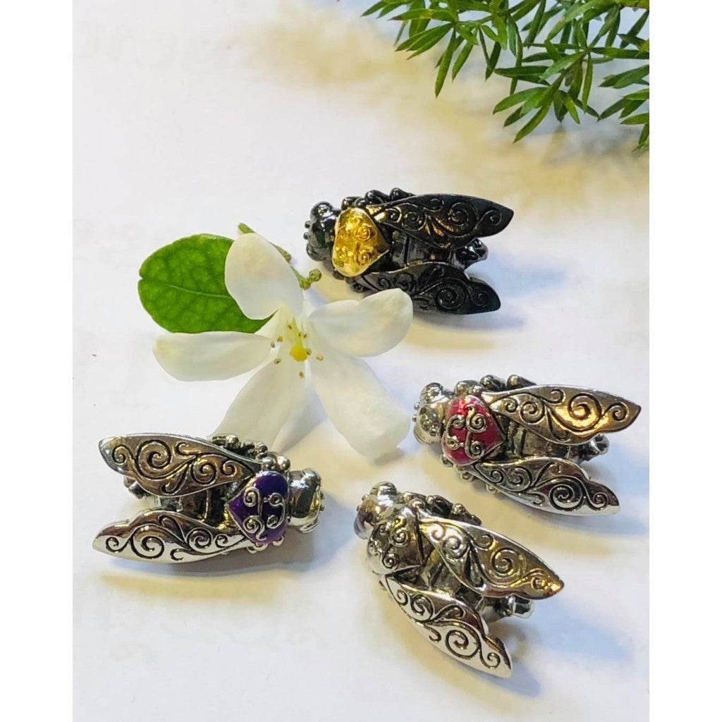 Golden bumblebee wealth amulet in intricate silver design with colorful gemstones and floral accents