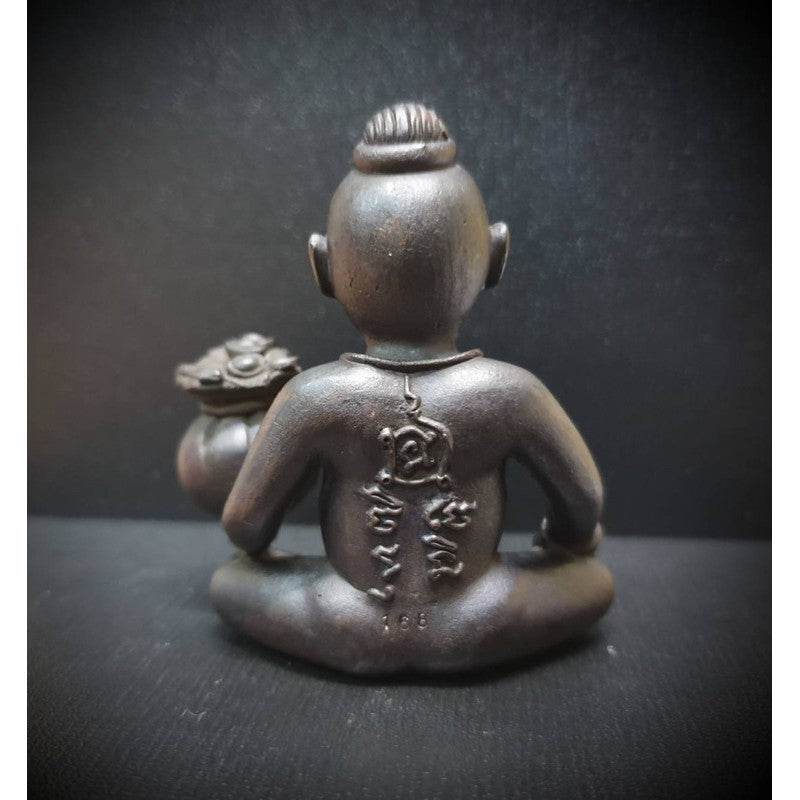 Back view of the guardian boy wealth figurine with intricate detailing and a treasure pot