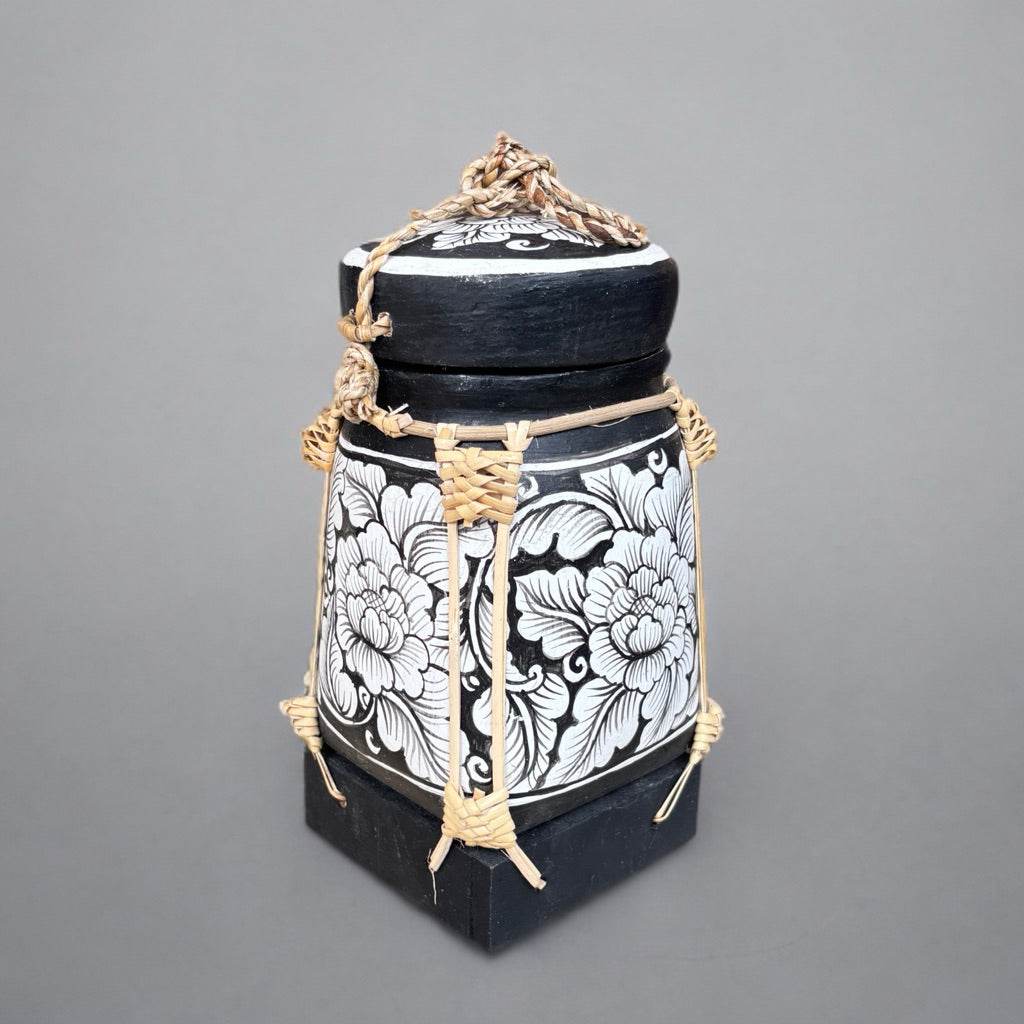 Handcrafted bamboo jewelry box with black and white floral design and natural woven accents