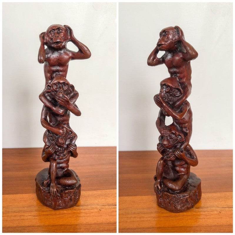 Wooden sculpture of three monkeys stacked covering eyes ears and mouth for buddhist mindfulness home decor
