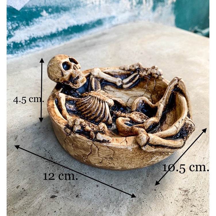 Handcrafted resin skeleton ashtray with detailed reclining skeleton design and size dimensions