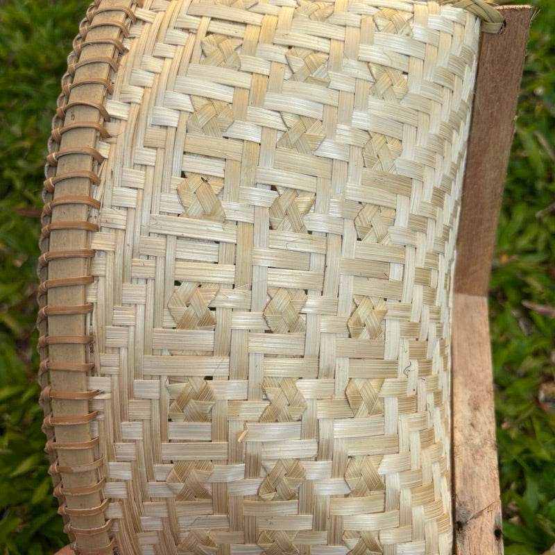 Close-up of handmade Thai bamboo basket showing detailed natural woven pattern and texture