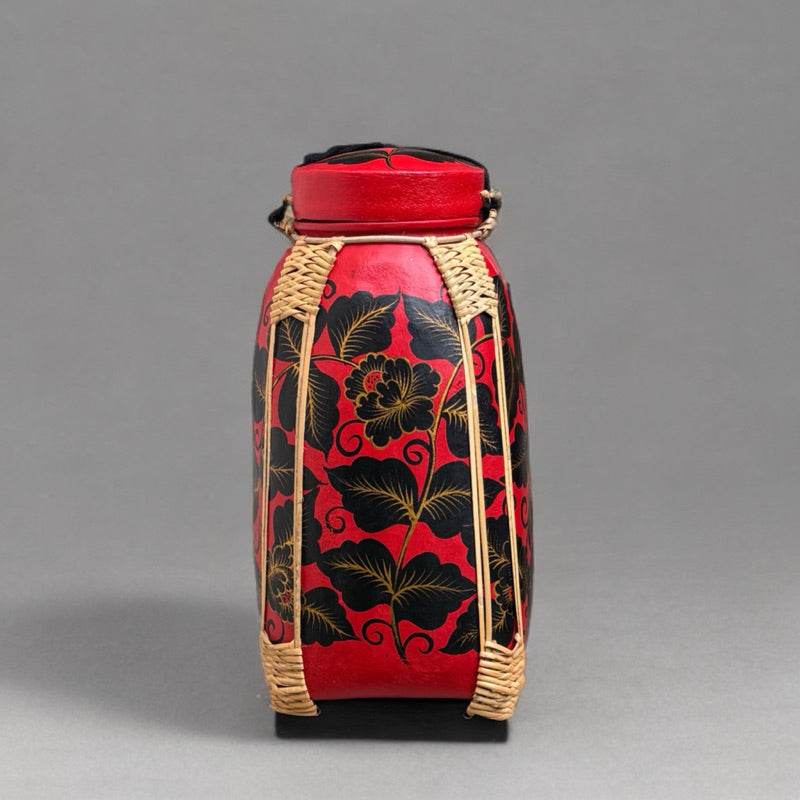 Handmade Thai bamboo rice basket with red and black floral design from One-Sake.com