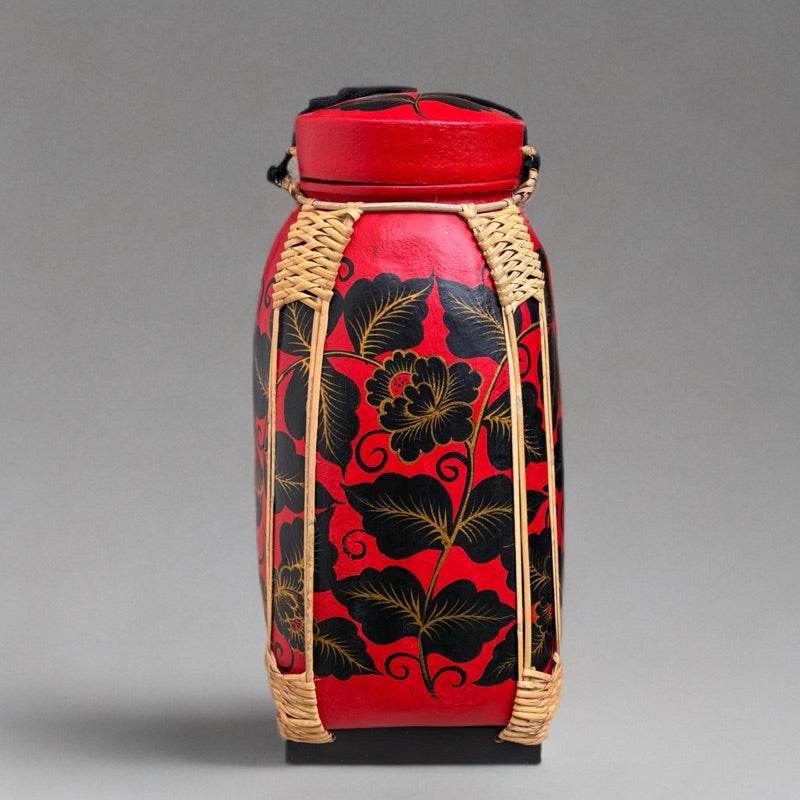 Handmade Thai bamboo rice basket with red and black floral design and woven bamboo accents