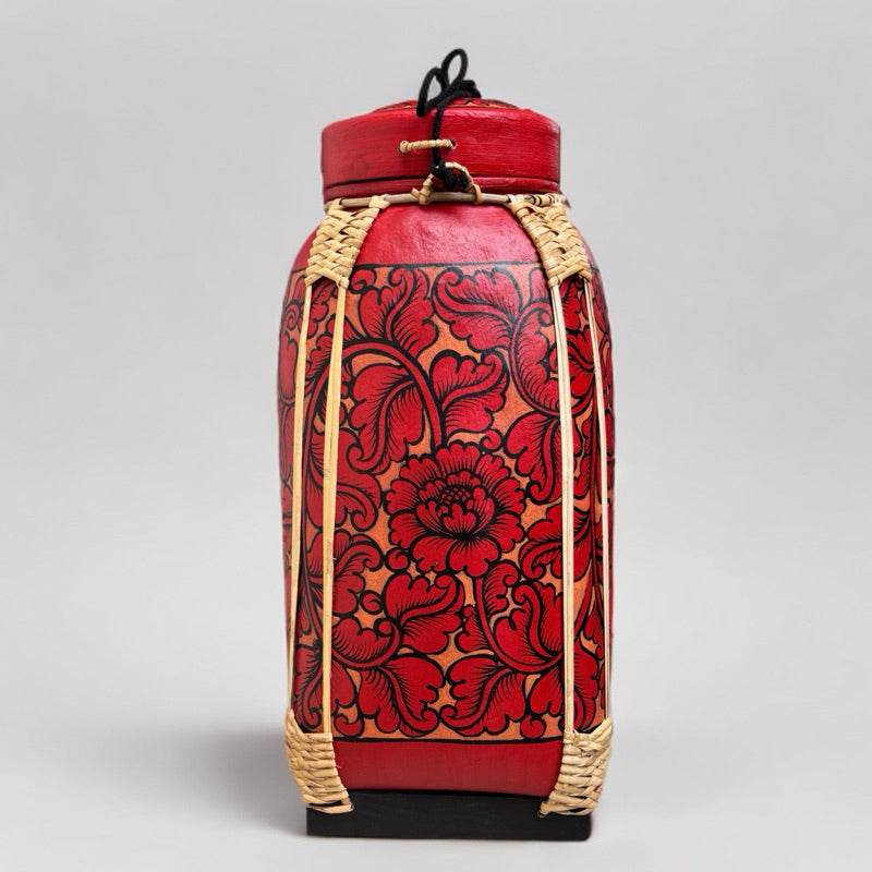 Handmade Thai bamboo rice basket with red floral design and woven bamboo details for food storage