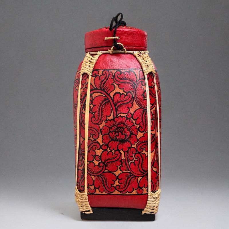 Handmade Thai bamboo rice basket with red floral design and woven detailing