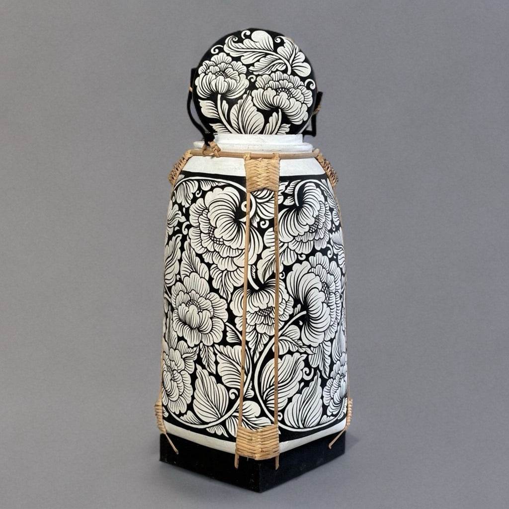 Handmade Thai bamboo rice basket with intricate black and white floral patterns from One-Sake.com