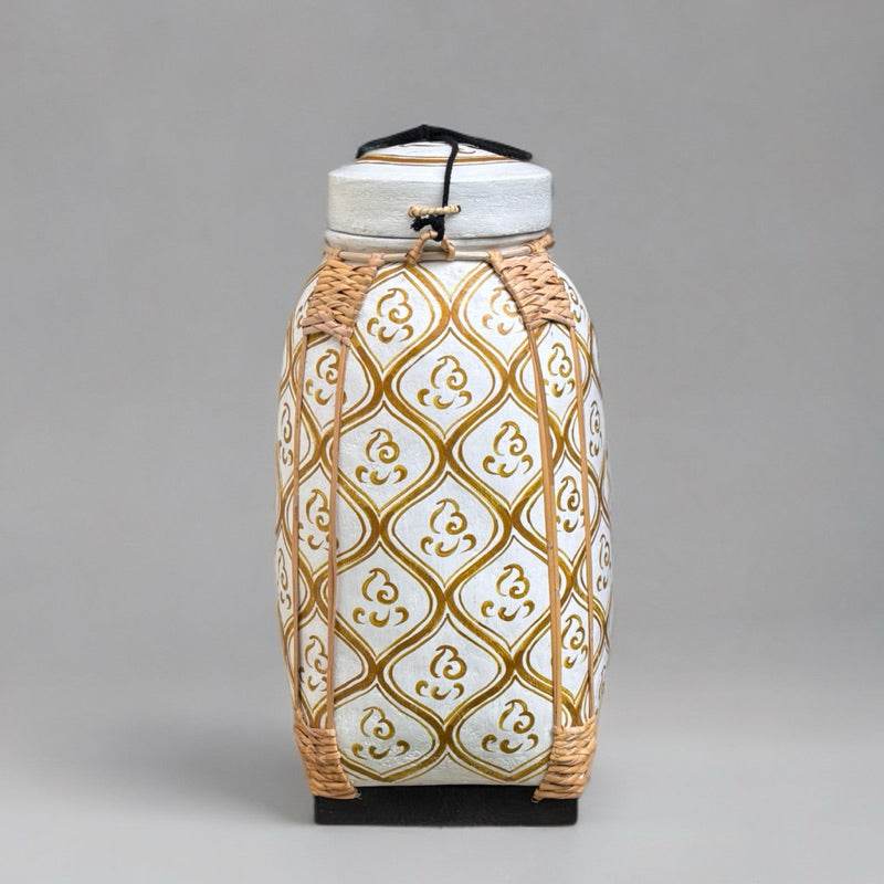 Handmade Thai bamboo rice basket with white and gold decorative pattern for food storage