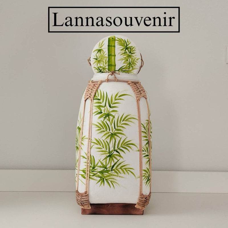 Handmade Thai bamboo rice basket with green leaf design and woven natural bamboo frame