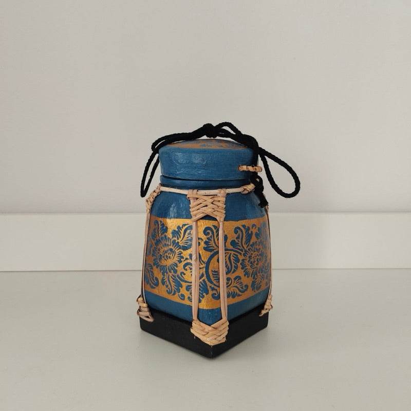 Handmade Thai bamboo rice box with blue and gold floral design and black cord from One-Sake.com