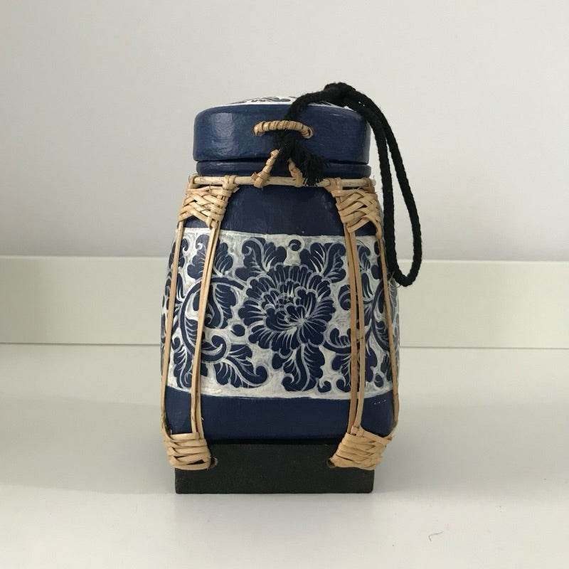 Handmade Thai bamboo rice box with blue floral ceramic design and woven bamboo frame