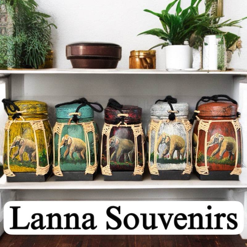 Set of colorful handmade Thai bamboo rice box containers with elephant designs displayed on shelf