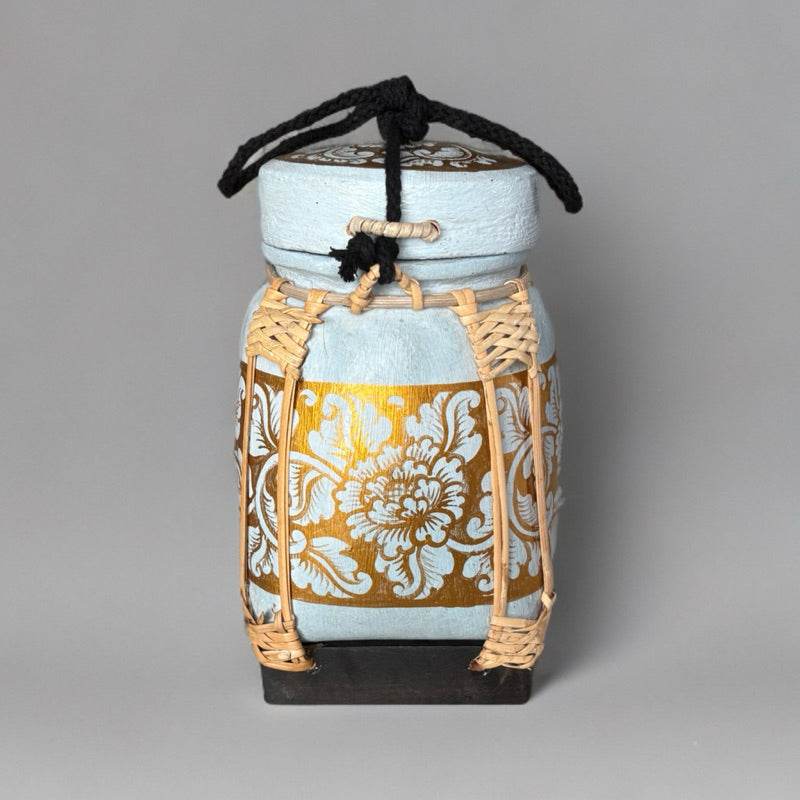 Handmade Thai bamboo rice box with intricate gold floral design and woven bamboo details