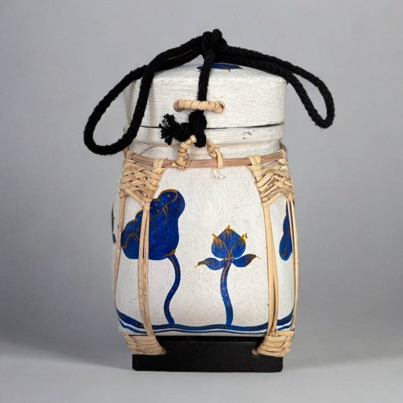 Handmade Thai bamboo rice box with blue floral design and black carrying strap