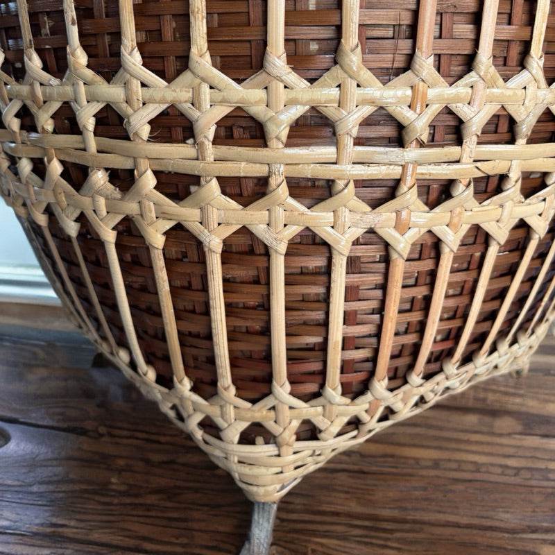 Close-up detail of handwoven bamboo rattan basket showing intricate weaving craftsmanship