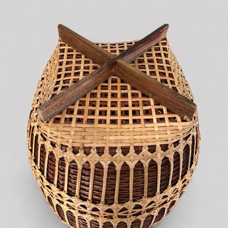 Handwoven bamboo rattan basket with wooden cross handle perfect for home storage and organization