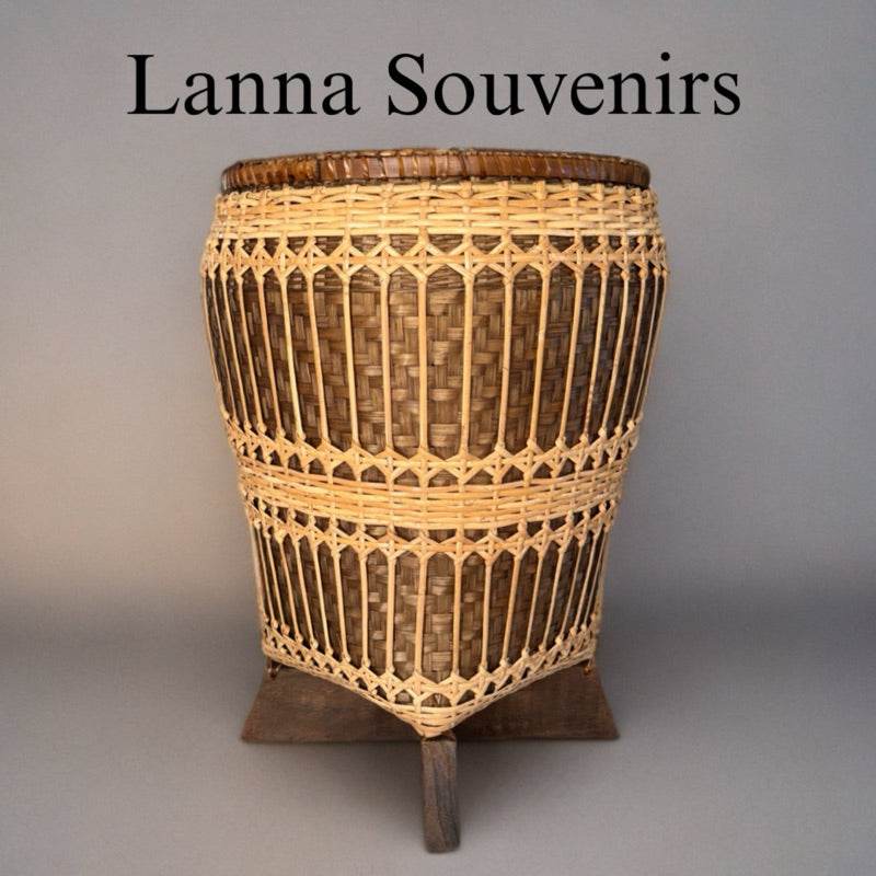 Handwoven bamboo rattan basket with intricate design and wooden stand for home storage