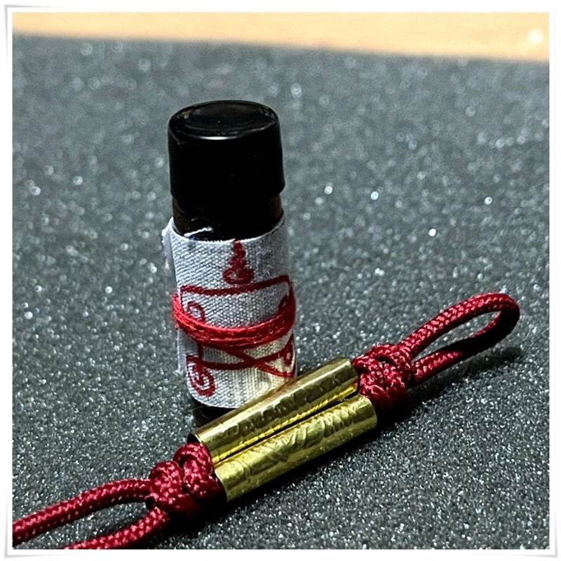 Khmer attraction oil for love and luck in a decorative bottle with a protective charm